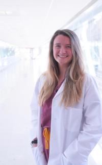 Smiling woman in white coat